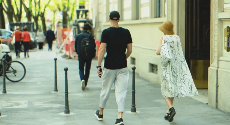 Couple walking down the street | Source: Shutterstock