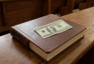 Every first Sunday for nine years, I have found a fifty-dollar bill inside my hymnal. No note, just a clean bill tucked into the pages, always in my pew.